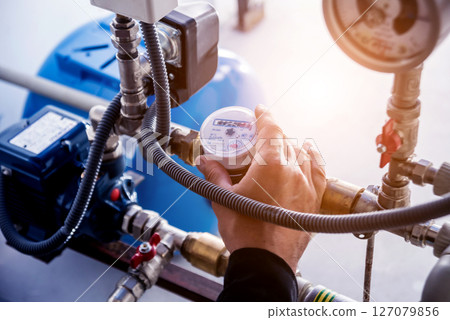 Technician checking water system nodes.Modern Industrial background Technician checking water system nodes.Modern Industrial background 127079856