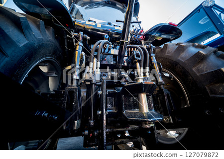 Rear view of modern agricultural tractor. Industrial details. Rear view of modern agricultural tractor. Industrial details. 127079872