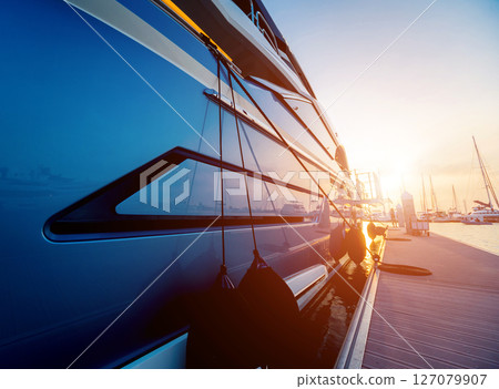 View of harbor with yachts details. Beautiful sunset sky in the marina bay. 127079907