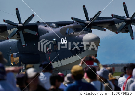 The Japan Maritime Self-Defense Force's gigantic US-2 fighter jet landed on a heat-stained runway as spectators looked on. The Japan Maritime Self-Defense Force's gigantic US-2 fighter jet landed on a heat-stained runway as spectators looked on. 127079920