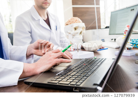 Two doctors having medical council in hospital. Two doctors having medical council in hospital. 127079939