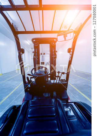 Forklift in a large industrial freezer warehouse. Empty warehouse Forklift in a large industrial freezer warehouse. Empty warehouse 127080001