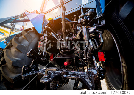 Rear view of modern agricultural tractor. Industrial details. 127080022