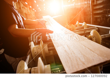 Carpenter with fibreboards at furniture factory workshop. Woodworking industry 127080092