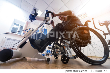 Disabled man training in the gym. Rehabilitation center 127080146