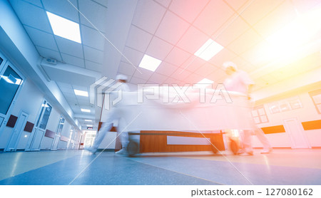 Nurses moves medical stretcher with patient at hospital. Medical equipment. 127080162