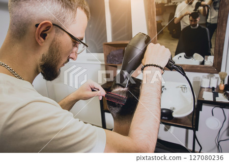 Young man with trendy haircut at barber shop.  127080236