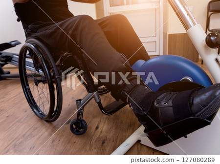 Disabled man training in the gym. Rehabilitation center 127080289