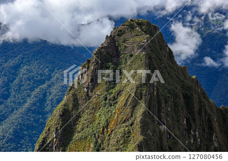 Huaynapicchu mountain towering behind the ruins of Machu Picchu in Peru, South America 127080456