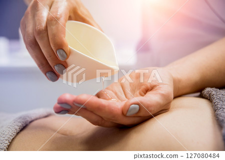 Beautiful young woman enjoying massage in spa salon. Cosmetology Beautiful young woman enjoying massage in spa salon. Cosmetology 127080484