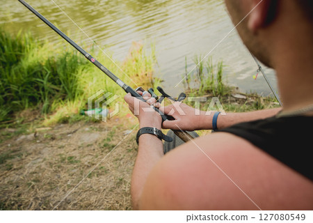 Handicapped man fishing at a lake. Wheelchair camping. Handicapped man fishing at a lake. Wheelchair camping. 127080549