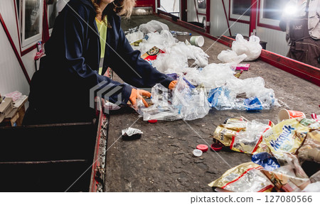 At modern recycling plant. Separate garbage collection. Workers sorting trash 127080566