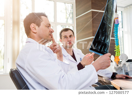 Doctors team having medical council in hospital. Discussing medical issues. Doctors team having medical council in hospital. Discussing medical issues. 127080577