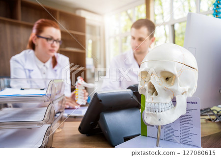 Two doctors having medical council in hospital. Discussing medical issues. Two doctors having medical council in hospital. Discussing medical issues. 127080615