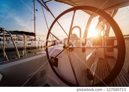 A modern speed boat yacht steering wheels. 127080713