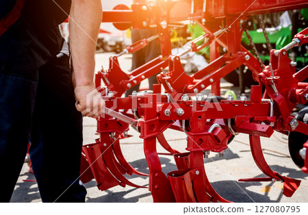 The mechanics repair combine harvester. Modern agricultural machinery 127080795