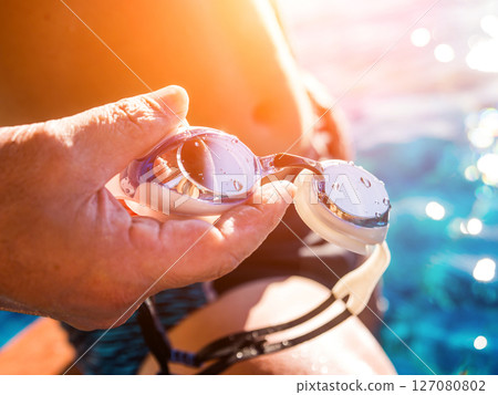 Young athletic man swimming in the swimming pool Young athletic man swimming in the swimming pool 127080802
