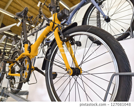 A variety of bicycles are hanging on a rack inside a sport store A variety of bicycles are hanging on a rack inside a sport store 127081048