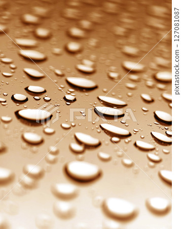 The water drops resting upon a smooth surface showcasing their beauty and details The water drops resting upon a smooth surface showcasing their beauty and details 127081087