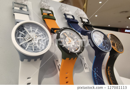 MAY 18, 2025 - PHUKET, THAILAND: A vibrant array of colorful watches is displayed in a row MAY 18, 2025 - PHUKET, THAILAND: A vibrant array of colorful watches is displayed in a row 127081113
