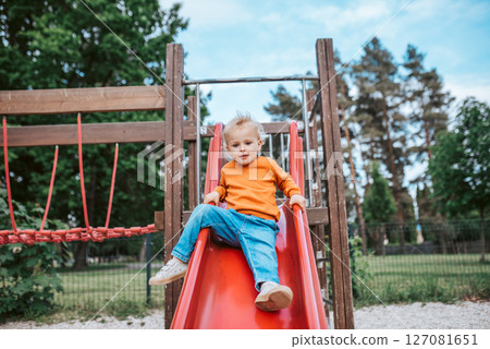 Little boy getting ready to slide 127081651