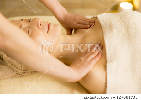 Senior woman receiving massage at beauty salon Senior woman receiving massage at beauty salon 127081733