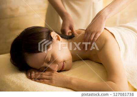 Senior woman receiving massage at beauty salon Senior woman receiving massage at beauty salon 127081738