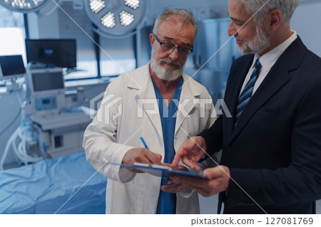 Doctor signing contract with pharmaceutical representative. 127081769