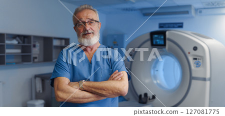 Medical specialist standing by CT scanner, looking at camera, banner with copy space. Medical specialist standing by CT scanner, looking at camera, banner with copy space. 127081775