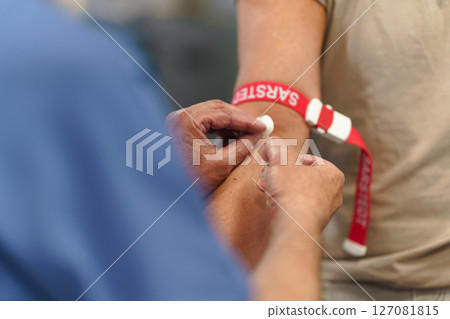 Doctor taking patient's blood pressure using digital blood pressure monitor. Doctor taking patient's blood pressure using digital blood pressure monitor. 127081815