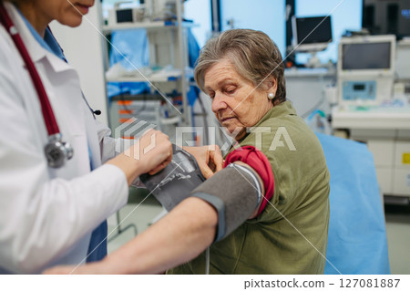 Senior woman having blood pressure checked, preventive care. Senior woman having blood pressure checked, preventive care. 127081887