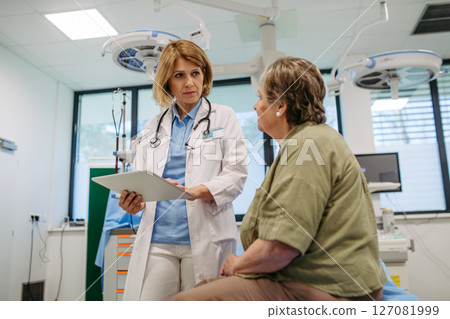 Geriatrician talking about test results with senior patient during check-up. 127081999