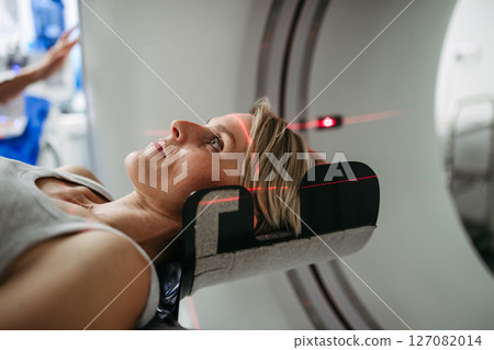 Patient positioned for head scan with laser alignment in CT scanner 127082014