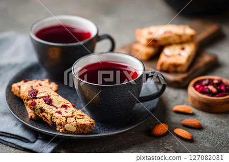 elegant presentation of herbal tea paired with almond biscotti 127082081
