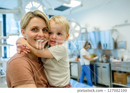 Portrait of beautiful mother with little toddler son during examination in medical clinic. 127082100