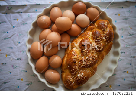 Homemade braided bread and eggs on rustic kitchen table Homemade braided bread and eggs on rustic kitchen table 127082231