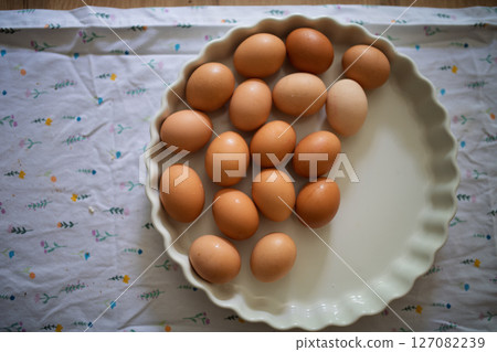 Fresh brown eggs in porcelain bowl Fresh brown eggs in porcelain bowl 127082239
