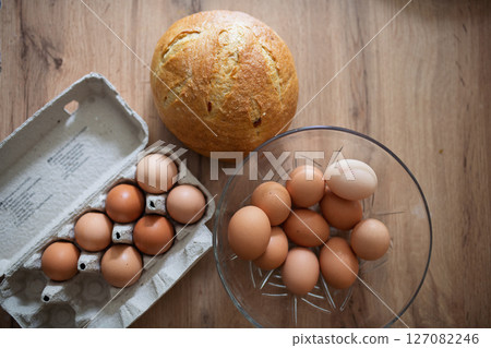 Fresh brown eggs in carton and glass bowl Fresh brown eggs in carton and glass bowl 127082246