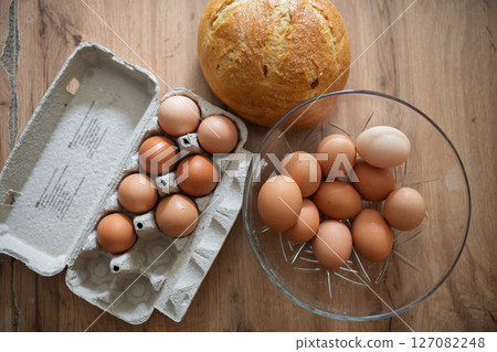 Fresh brown eggs in carton and glass bowl Fresh brown eggs in carton and glass bowl 127082248