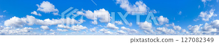 Panoramic fluffy cloud in the blue sky. Sky with cloud on a sunny day. 127082349