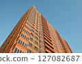 multi-storey new yellow brick house against the blue sky. Mortgage, real estate, new housing, copy space. 127082687