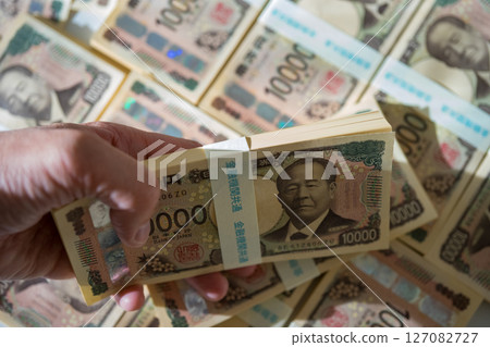 man's hand with a wad man's hand with a wad 127082727