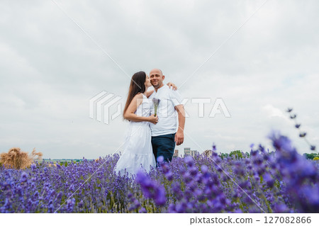 A husband and wife in love in a lavender field 127082866