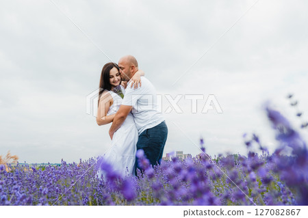 The young girl bows her head, enjoying the warmth of her lover's hands The young girl bows her head, enjoying the warmth of her lover's hands 127082867