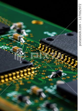 High Resolution Macro Close Up of Modern Microchip on Green Printed Circuit Board with Gold Connectors and Electronic Components for Technology Concepts 127082972