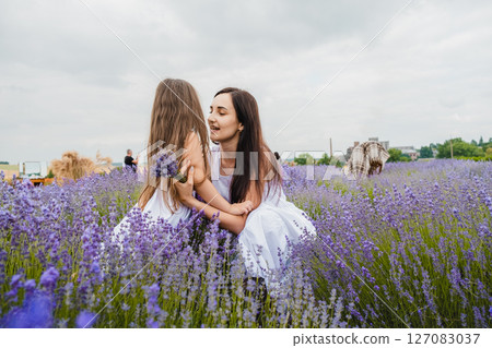 In the lavender field, a young mother waits for her little daughter In the lavender field, a young mother waits for her little daughter 127083037
