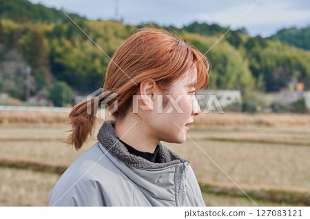 Woman gazing into the distance in nature Woman gazing into the distance in nature 127083121