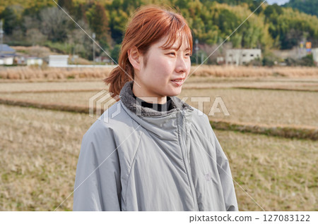 Woman gazing into the distance in nature Woman gazing into the distance in nature 127083122