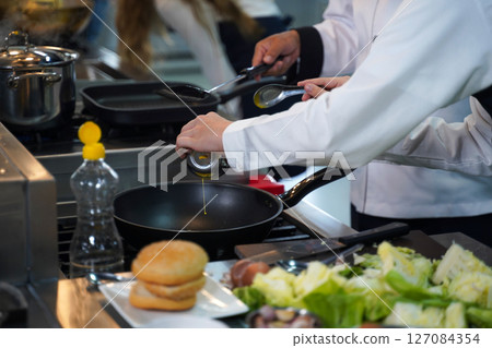 Close up.  Chef teacher teaches cooking to the group children  127084354