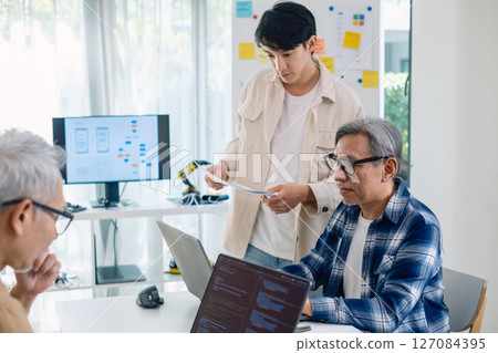Asian Instructor Teaching Senior in Software Programming and Training Collaboration Asian Instructor Teaching Senior in Software Programming and Training Collaboration 127084395